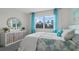 Bedroom with a modern dresser, large window, blue curtains, and comfortable bed at 3326 Arch Ave, Ormond Beach, FL 32174
