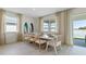 Dining room with large windows offering beautiful water views, stylish surf board art pieces and seating for eight at 3326 Arch Ave, Ormond Beach, FL 32174
