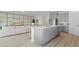 Spacious kitchen island with grey cabinets and open floor plan to living room at 3326 Arch Ave, Ormond Beach, FL 32174