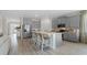 Open kitchen featuring an island with seating, stainless steel appliances, and gray cabinetry at 3326 Arch Ave, Ormond Beach, FL 32174