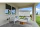 Relaxing covered patio with stylish seating, providing a perfect outdoor retreat overlooking the lawn at 3326 Arch Ave, Ormond Beach, FL 32174