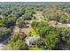 Aerial view of home with mature trees, surrounded by lush landscaping at 33925 Highland Rd, Leesburg, FL 34788