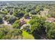 Expansive aerial view of a home surrounded by lush greenery and mature trees in a serene setting at 33925 Highland Rd, Leesburg, FL 34788