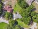 Aerial view of a well-maintained home with beautiful landscaping, mature trees, and manicured lawn at 33925 Highland Rd, Leesburg, FL 34788