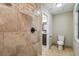 Updated bathroom features a tiled walk-in shower and a separate toilet for added privacy and convenience at 33925 Highland Rd, Leesburg, FL 34788