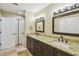 Bathroom features double vanity with granite counters and updated fixtures, complemented by tile floors at 33925 Highland Rd, Leesburg, FL 34788
