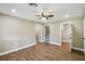 An airy bedroom with wood-look flooring, a ceiling fan and multiple doors, with lots of light at 33925 Highland Rd, Leesburg, FL 34788