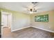 Inviting bedroom with wood-look floors, ceiling fan, natural light, and a calming color scheme at 33925 Highland Rd, Leesburg, FL 34788