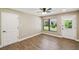 Bedroom with wood-look flooring, natural light, and multiple entryways, for flexible living at 33925 Highland Rd, Leesburg, FL 34788