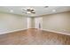 Spacious bedroom features wood floors, a ceiling fan, and multiple doorways for easy access at 33925 Highland Rd, Leesburg, FL 34788