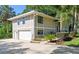 Two-story home with a two-car garage, neutral paint and well-maintained landscaping on a concrete driveway at 33925 Highland Rd, Leesburg, FL 34788