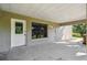 View of the covered patio with concrete floors, neutral walls, and view of the yard at 33925 Highland Rd, Leesburg, FL 34788