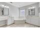 Bright bathroom featuring a soaking tub, dual vanities, and plenty of counter space at 3539 Foxcroft Cir, Oviedo, FL 32765