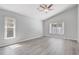 Airy bedroom with vaulted ceiling, ceiling fan and natural light through the windows at 3539 Foxcroft Cir, Oviedo, FL 32765