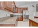 Updated kitchen with stainless steel refrigerator and plenty of granite countertop space at 3539 Foxcroft Cir, Oviedo, FL 32765