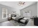 Airy main bedroom with vaulted ceiling, ceiling fan and natural light through the windows at 3539 Foxcroft Cir, Oviedo, FL 32765