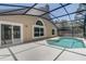 Inviting screened-in pool area with a pristine pool, ideal for relaxing and enjoying the outdoors at 3539 Foxcroft Cir, Oviedo, FL 32765