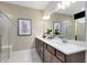 Elegant bathroom featuring a double sink vanity with modern fixtures and a glass-enclosed shower at 3814 Blue Vale Dr, Davenport, FL 33837