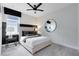 Cozy bedroom featuring neutral tones, contemporary decor, and a ceiling fan for added comfort at 3814 Blue Vale Dr, Davenport, FL 33837