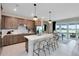 Open-concept kitchen with a large island, modern appliances, and seamless flow to outdoor living at 3814 Blue Vale Dr, Davenport, FL 33837