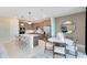 Modern kitchen with an island, stainless appliances, and stylish pendant lights and dining area at 3814 Blue Vale Dr, Davenport, FL 33837