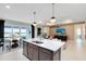 Stylish kitchen island view into the living room with modern decor and ample natural light at 3814 Blue Vale Dr, Davenport, FL 33837
