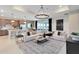 Open living room with modern decor, a large chandelier, and seamless access to the outdoor patio at 3814 Blue Vale Dr, Davenport, FL 33837