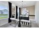 Bright living room featuring stylish furniture, sleek black accents, and ample natural light from large windows at 3814 Blue Vale Dr, Davenport, FL 33837