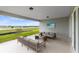 Spacious covered patio with comfortable seating and a view of the beautiful outdoor landscape at 3814 Blue Vale Dr, Davenport, FL 33837