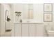 Bright bathroom showcasing a sleek vanity, modern fixtures, and ample storage space at 455 Puma Loop, Groveland, FL 34736