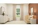 Cozy Bedroom with charming decor, crib, accent chair, and soft natural light at 455 Puma Loop, Groveland, FL 34736