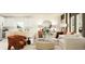 Open concept living room with modern furniture, bright light, and view to kitchen at 455 Puma Loop, Groveland, FL 34736