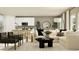 Inviting living room open to the kitchen, featuring stylish furniture, neutral colors, and modern decor at 459 Puma Loop, Groveland, FL 34736