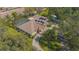 Beautiful aerial view of home with screened pool, solar panels, long driveway, and mature landscaping at 4735 Chelsea Ct, Kissimmee, FL 34744