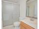 Bathroom with glass-enclosed shower, vanity, and large mirror at 4735 Chelsea Ct, Kissimmee, FL 34744