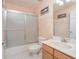 A full bathroom with a vanity, toilet and shower with glass doors at 4735 Chelsea Ct, Kissimmee, FL 34744