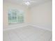 Bright bedroom with tile flooring, large window, and ceiling fan at 4735 Chelsea Ct, Kissimmee, FL 34744
