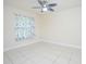 A bedroom with tile floor, overhead fan and decorative curtains at 4735 Chelsea Ct, Kissimmee, FL 34744
