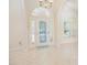The foyer features a decorative front door, tile floors, and arched windows at 4735 Chelsea Ct, Kissimmee, FL 34744