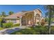 Attractive single-story home featuring a columned front porch and well-maintained landscaping, exuding curb appeal at 4735 Chelsea Ct, Kissimmee, FL 34744