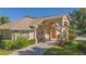 Attractive single-story home featuring a columned front porch and well-maintained landscaping, exuding curb appeal at 4735 Chelsea Ct, Kissimmee, FL 34744