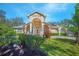 Inviting single Gathering home with a columned entrance and colorful shrubs, offering a warm and welcoming curb appeal at 4735 Chelsea Ct, Kissimmee, FL 34744