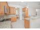 Bright kitchen boasts stainless steel appliances, granite countertops, and wood cabinetry at 4735 Chelsea Ct, Kissimmee, FL 34744