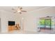 Open living room with tv, doorway and view of pool at 4735 Chelsea Ct, Kissimmee, FL 34744