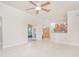 Spacious living room with tile flooring and view into the kitchen at 4735 Chelsea Ct, Kissimmee, FL 34744
