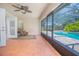 Screened patio with tile flooring, ceiling fan, and view of the pool at 4735 Chelsea Ct, Kissimmee, FL 34744