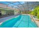 A beautiful screened-in pool with a spa and lush landscaping at 4735 Chelsea Ct, Kissimmee, FL 34744