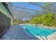 A lovely pool with a screen, lush landscaping and a jacuzzi at 4735 Chelsea Ct, Kissimmee, FL 34744