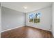 Well-lit bedroom with wood-style flooring and a view from the large window at 4785 Cumbrian Lakes Dr, Kissimmee, FL 34746