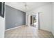 Airy bedroom with tile floors and a sliding glass door that leads to a screened-in porch or patio at 4785 Cumbrian Lakes Dr, Kissimmee, FL 34746